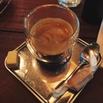 Espresso with a small piece of cheese and bacon caramel
